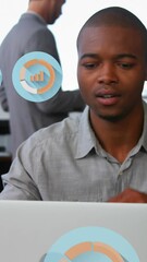Poster - Animation of multiple graph icons over tired african american man looking at laptop in office