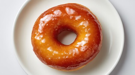 Poster - Freshly Glazed Doughnut on White Plate Perfect for Breakfast or Snack, Captivating Golden Color and Tempting Texture Ideal for Food Photography or Culinary Projects