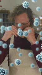 Poster - Animation of virus cells over caucasian man with face mask in workshop