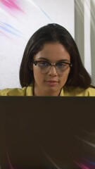 Poster - Animation of pink and blue colours over asian woman using laptop