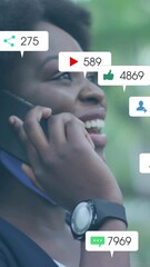 Poster - Animation of social media icons over african american woman with face mask using smartphone