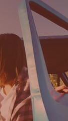 Poster - Caucasian woman getting out of the car and opening the hood on the street