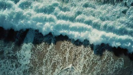 Poster - A wave crashes against the shore of a large ocean, suggesting turbulent weather or strong surf