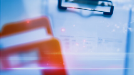 Poster - Blurred Business Documents: An abstract image of blurred business documents, with a focus on a red object, possibly a calculator or phone, suggesting business activity and data analysis.