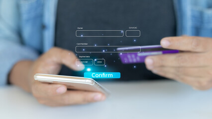 Close-up of man using smartphone and credit card for online payment and mobile banking transaction, showing digital finance and e-commerce purchase.