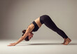 © Eira - woman doing downward facing dog yoga pose