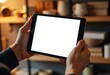 © starush - Hands holding a tablet with a blank screen in a cozy setting