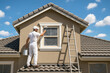 © Andrew - Professional house painter in white overalls painting exterior window trim with roller on rooftop. Ladder, bucket, stucco facade, blue sky. Home improvement, renovation, maintenance concept.