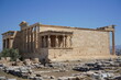 © Yurii Levko - Ancient architecture stands proud under the clear blue sky in Athens, showcasing the rich heritage and artistry of classical Greece at the Acropolis site of Erechtheion