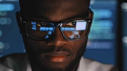 Poster - Coding Genius: A focused african descent man is intently coding, with lines of code reflecting in his glasses, epitomizing modern technology