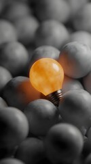 Poster - A glowing orange lightbulb stands out among gray bulbs