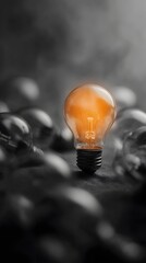 Poster - A glowing orange lightbulb stands out among grayscale bulbs
