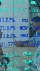 Poster - Financial data over people using laptop.