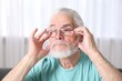 © New Africa - Senior man in glasses suffering from eyestrain at home