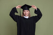 © New Africa - Happy student after graduation on green background