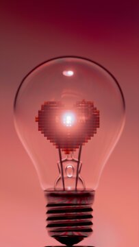 Light bulb with pixelated heart shaped filament under radial striped background