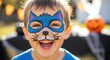 © NN AI - Happy child with blue cat face paint smiling joyfully showing painted whiskers and nose design. Cute toddler with colorful animal makeup. Children entertainment concept