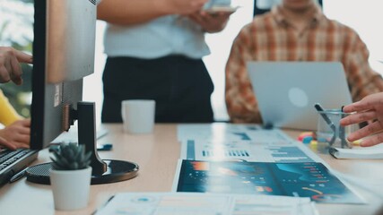 Poster - A business team engages in a brainstorming session in a modern office setting, utilizing laptops and tablets for collaborative discussions on innovative strategies. SACTR