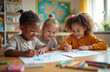© Vadym - Three diverse children happily draw with pencils during art class. Kids in classroom together. Early education, creativity development, fine motor skills. Learning project, homework. Cheerful