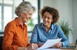 © Vadym - Senior woman with financial advisor review retirement plan in office. Elderly female consults with finance consultant for pension fund. Conversation paperwork, discussion of savings, investment,