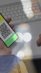 Poster - Animation of man holding smartphone with covid 19 vaccination passport over blurred lights