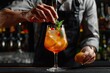 © Boneka - Vibrant Picture of Barman Decorating a Glass of Alcoholic Cocktail