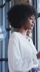 Poster - Animation of social media icons over african american businesswoman