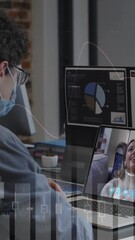 Poster - Animation of financial graphs over caucasian man in face mask having video call in office