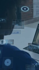 Poster - Animation of round scanners over african american woman having a video call on laptop at office