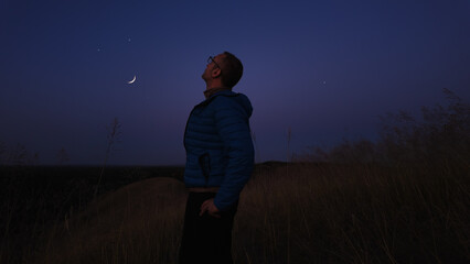 Wall Mural - amateur astronomer watching stars, moon, planets and other celestial objects from a countryside fiel