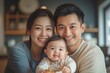© Sanny Rada - Happy family moment: Asian parents eating breakfast with their young child in the kitchen, Generative AI