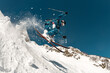 © cppzone - A skier performs a risky trick with a high jump, sliding down the mountain off-piste, with cloud of snow around him