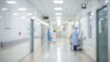 © Worldwide - Blurred hospital corridor with medical staff attending to patients.