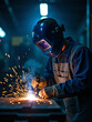 © Jelly - Close-up of industrial welder at work creating bright electric sparks while fusing metal in a modern fabrication workshop with protective gear, cinematic lighting, and intense manual precision