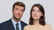 © TH_Stock - A young man and woman, both looking up and to the side with thoughtful or curious expressions, against a neutral background.