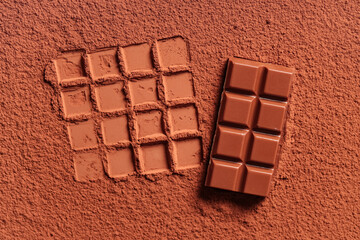 Wall Mural - Tasty sweet chocolate on cocoa powder
