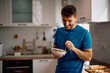 © Drazen - Happy man eating oatmeal with fresh fruit for breakfast.
