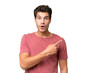 Young handsome caucasian man over isolated background surprised and pointing side