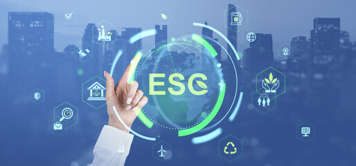 Poster - ESG environmental social governance concept with business icons and glowing interface over cityscape background and hand pointing at virtual screen.
