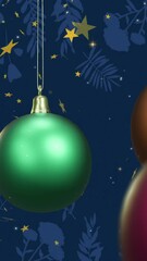 Wall Mural - animation of shiny christmas baubles with floating gold stars on dark blue background