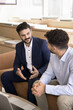 © fizkes - Business consulting and expert advice. Experienced businessman professional lawyer insurer sales manager explain deal detail to interested client make good offer provide consultation in casual setting