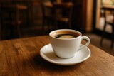 Steaming brew served in a white mug on a rustic wooden surface inside a cozy cafe