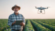 © Лилия Захарчук - natural soft lighting, new generation farmer using tablet beside drone hovering over crop field