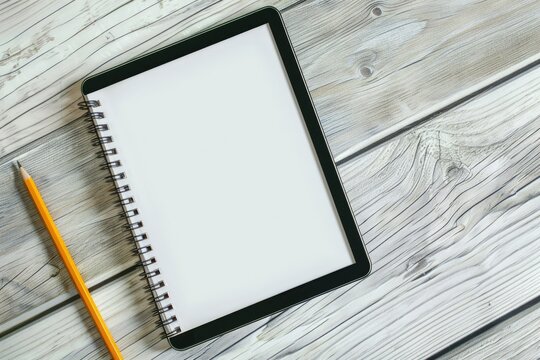 High Quality Picture of Digital Tablet and Spiral Notebook with Pencil Over the Wooden Table