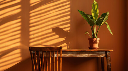 Aufkleber - Minimalist desk with wooden chair and potted plant creates serene atmosphere, enhanced by warm sunlight casting shadows on wall
