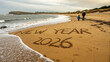 © md - A family walks along a beach where new year 2026 is written in the sand