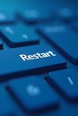 Poster - A close-up shot of a keyboard's restart button, vertical composition. The deep blue color palette and shallow depth of field create a professional and modern feel.