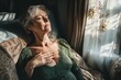 © Ilia - Elderly woman relaxing in sunlit room with eyes closed