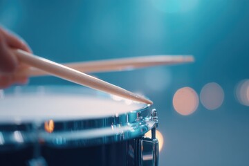 Poster - close-up of drummer hands gripping brushes and snare caught in mid-sweep motion under ambient light