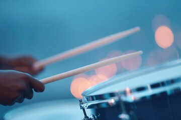 Poster - close-up of drummer hands gripping brushes and snare caught in mid-sweep motion under ambient light